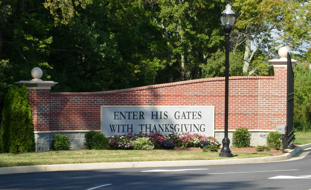 Church sign located on a red brick gate-like feature