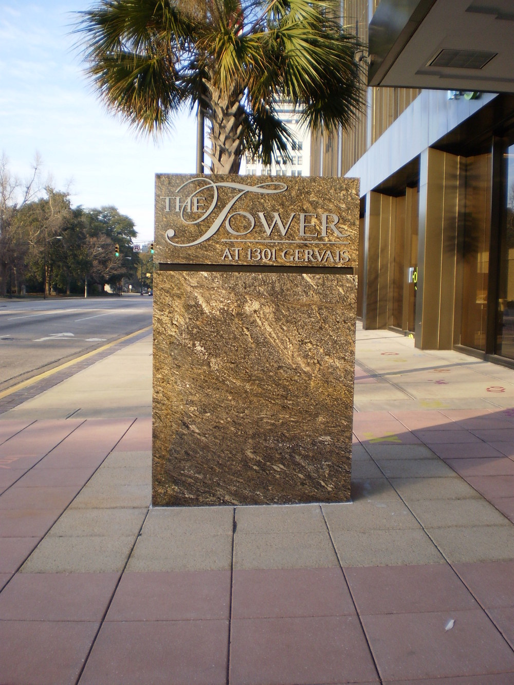 Brown marble pillar engraved with logo