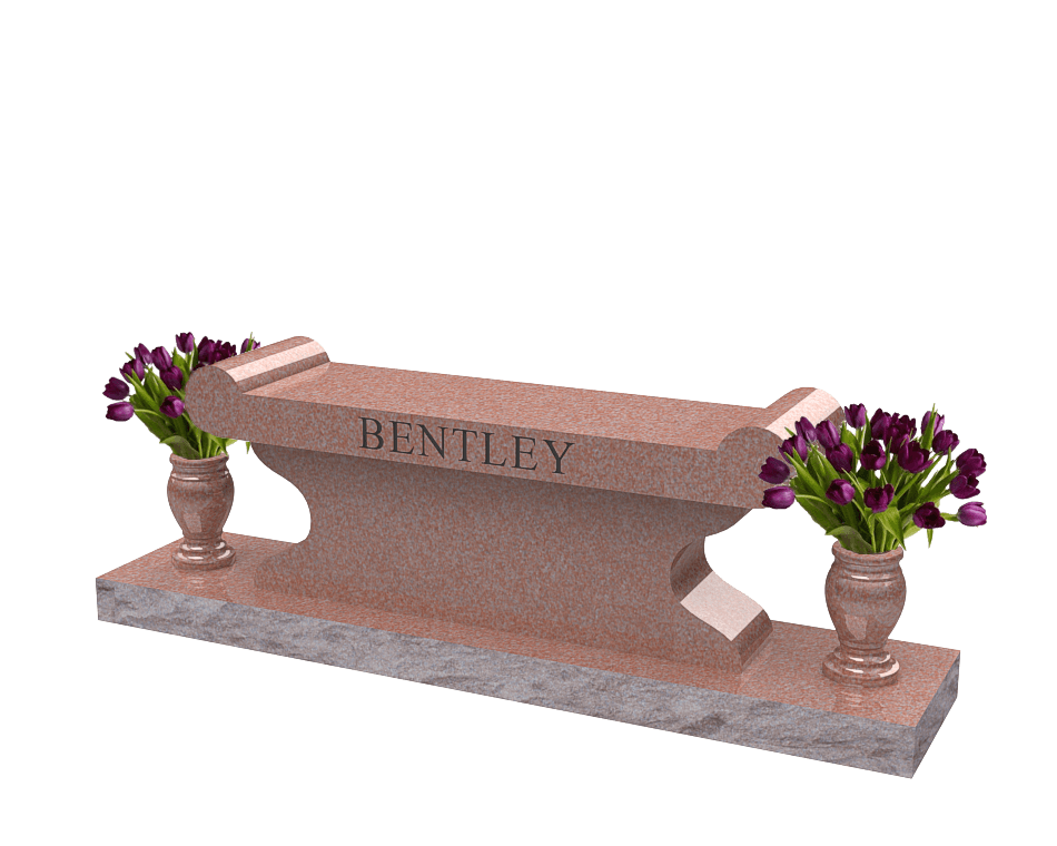 Red granite bench with scroll style seating area and a vase at each end.