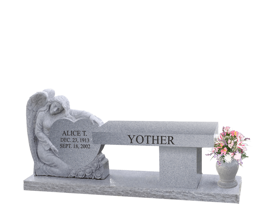 Light grey bench with an angel draped over a heart statue on the left and a vase on the right