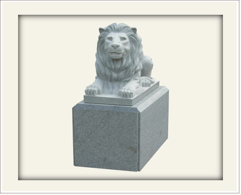 Statue of a lion laying on a box