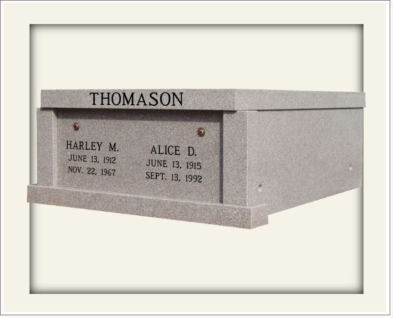 Light grey stone mausoleum with family name and individual information engraved in black