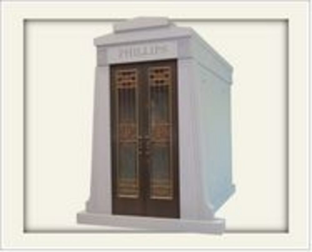 Tall light grey stone mausoleum with metal doors