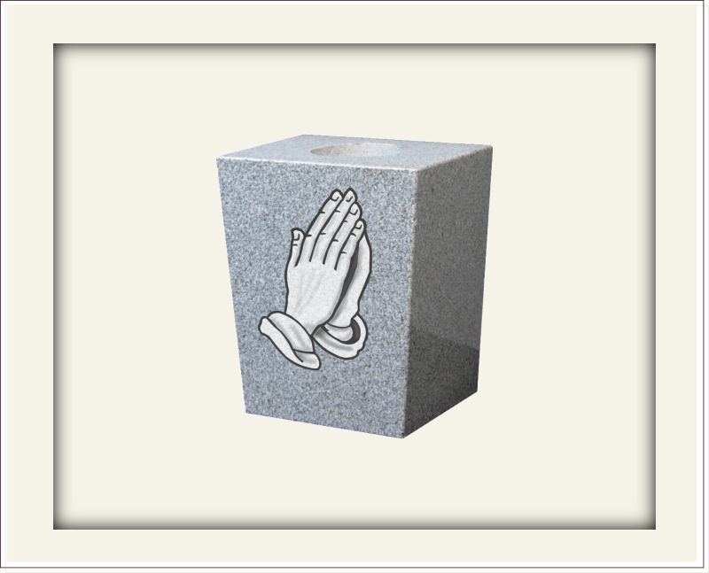 Sample of a grey square vase with praying hands etched on one side